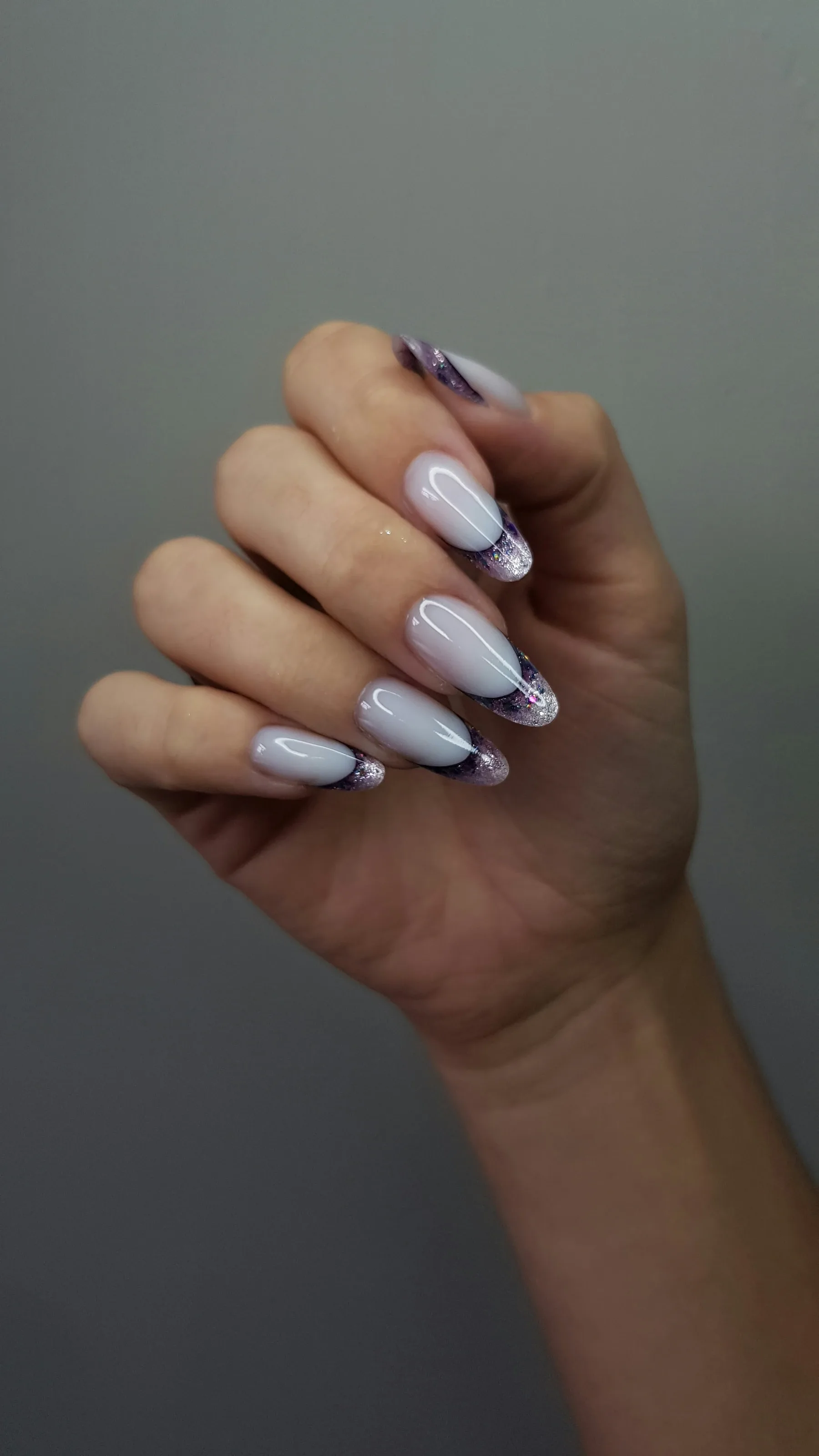 Almond nails with a lilac base and a dark French tip